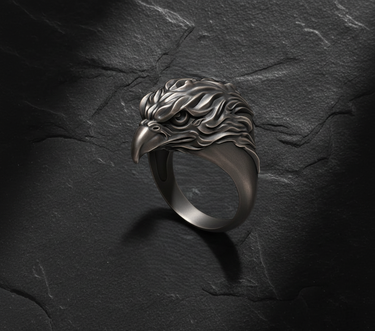 Side profile of oxidized silver eagle ring showing fierce eye detail and swept-back feather design
