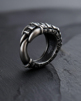 Side view of 925 sterling silver crow claw ring featuring oxidized scales on dark textured background