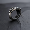 Side view of 925 sterling silver crow claw ring featuring oxidized scales on dark textured background