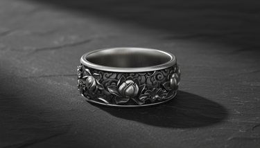 925 sterling silver lotus flower ring with intricate relief carving displayed on dark stone background