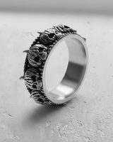 Side angle of 925 sterling silver skull ring showing smooth inner band and oxidized antique finish
