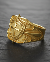 Front view of silver cross shield ring with gold vermeil finish and stippled texture details