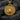 Two-tone round medallion pendant with gold lion center and silver rim displayed on charcoal