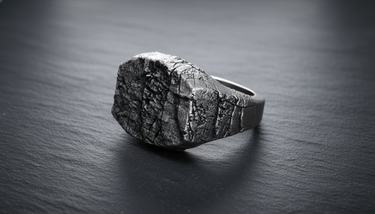 Front view of 925 sterling silver grunge stone signet ring with deep cracks and textured surface on black background