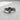 Side angle of handcrafted silver purity ring showing deep engraving and oxidized finish for contrast on grey background