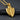 14K gold vermeil sword and shield pendant with fleur-de-lis details on dark stone background