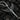 Oxidized 925 sterling silver dagger pendant featuring detailed angel wings resting on charcoal surface