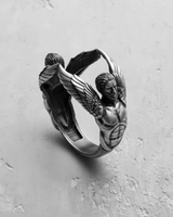925 sterling silver angel sculpture ring featuring two winged figures reaching together on grey background