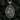 Angled view of silver religious pendant showing intricate relief and text details