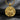 Gold vermeil assassin pendant featuring hooded figure holding sword on dark stone background
