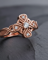 Side profile of rose gold Celtic cross ring variant displaying woven band pattern and stippled texture design
