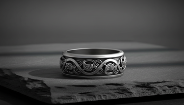 925 sterling silver Scandinavian wedding band featuring stylized waterbird and vine relief details on grey surface