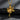 Gold vermeil angel with gun pendant hanging on chain against dark grey slate background