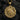 Close-up angled view of silver religious medallion showing depth of the crown of thorns design and craftsmanship
