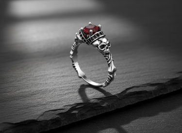 925 sterling silver skull engagement ring featuring a red gemstone and intricate bone band design on dark background