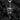 Front view of oxidized 925 sterling silver angel defender pendant holding an AK47 rifle against dark coal background