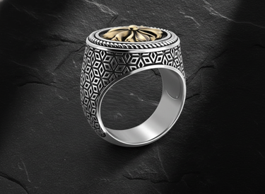 Side view of geometric pattern silver ring displaying intricate tessellated design and gold center