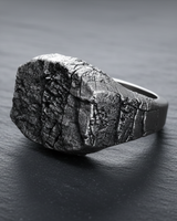 Side view of dark oxidized 925 sterling silver signet ring for men featuring rugged stone surface and deep grunge cracks
