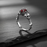 925 sterling silver skull ring featuring skeletal bone band and vibrant red center stone