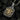 Angled view of oxidized silver bee pendant showcasing intricate scrollwork and beaded edges
