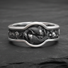 925 sterling silver Yin Yang Koi ring featuring two swimming fish in a circular bezel on a textured dark background