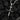 Handcrafted silver nail cross pendant made of 925 sterling silver resting on black charcoal background