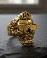Angled shot of silver bearded skull ring with glasses showing detailed texture and oxidized finish on dark background