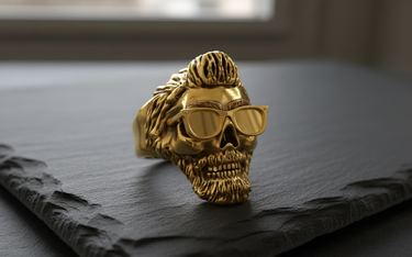 Angled shot of silver bearded skull ring with glasses showing detailed texture and oxidized finish on dark background