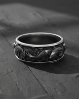 Angled view of handcrafted silver band ring with intricate koi carp relief and oxidized finish for men