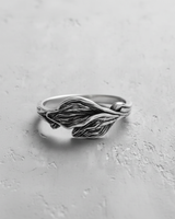 Handcrafted 925 sterling silver leaf ring featuring detailed vein texture and overlapping design on grey background
