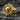 Gold vermeil skull rudder ring featuring a ship wheel design on a textured stone background