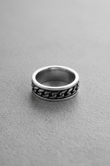 Angled view of silver fidget ring lying flat highlighting the oxidized detail of the loose chain mechanism