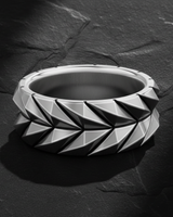 925 sterling silver geometric armor ring with raised triangular scale pattern on dark stone background