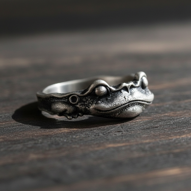 Angled view of handcrafted sterling silver frog ring highlighting realistic skin texture and band design