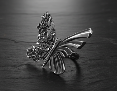 Close-up detail of silver butterfly ring highlighting the contrast between ribbed wing texture and flower motifs