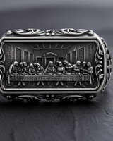 Front view of oxidized 925 sterling silver Last Supper ring with intricate religious carving and scrollwork