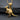 Gold vermeil kangaroo pendant featuring a mother and joey charm showcased on a textured dark slate background for contrast