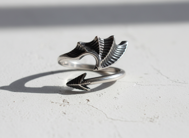Adjustable 925 sterling silver dragon wing ring with oxidized finish displayed on white background