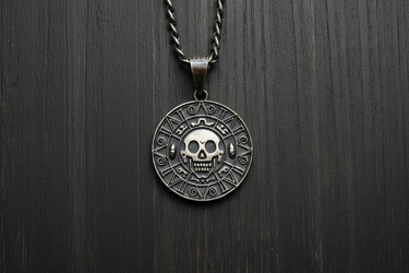 Oxidized 925 sterling silver Aztec skull coin pendant centered on dark wood background