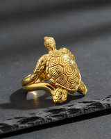 Gold vermeil sterling silver turtle ring with detailed shell pattern displayed on dark slate background
