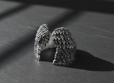 Side view of silver wings ring showing oxidized finish and intricate feather metalwork details