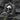 Angled view of silver skull ring showing detailed cranial features and textured setting