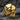 14K gold vermeil ornamental skull ring with polished forehead and intricate side scrollwork on textured rock