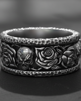 925 sterling silver skull rose ring featuring hammered edges and gothic motifs on a dark stone surface