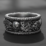925 sterling silver skull rose ring featuring hammered edges and gothic motifs on a dark stone surface