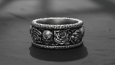 925 sterling silver skull rose ring featuring hammered edges and gothic motifs on a dark stone surface