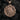 Gold plated religious medallion pendant depicting the profile of Jesus with thorns on dark texture