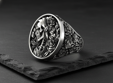 Angled shot of silver reaper rose ring showing deep relief carving of the skull profile and floral vines on the band
