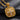 Angled shot of square silver cross medallion showing thick bail and detailed relief work in gold and silver tones