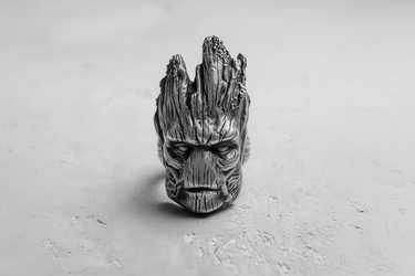 Close-up of silver Groot ring face with intricate wood grain carving and oxidized finish for depth and contrast